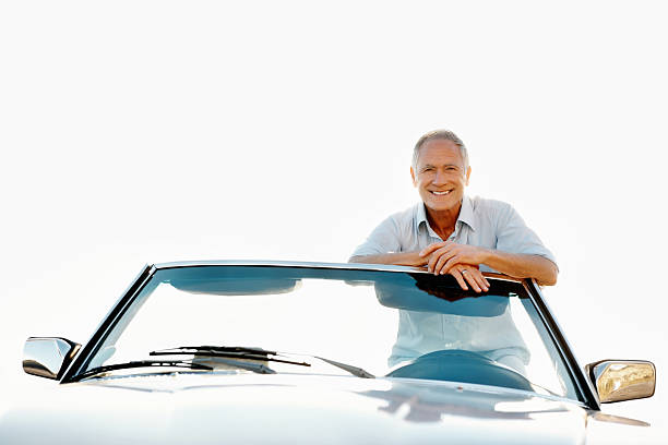 istock Senior man leaning on his car and smiling 184098918