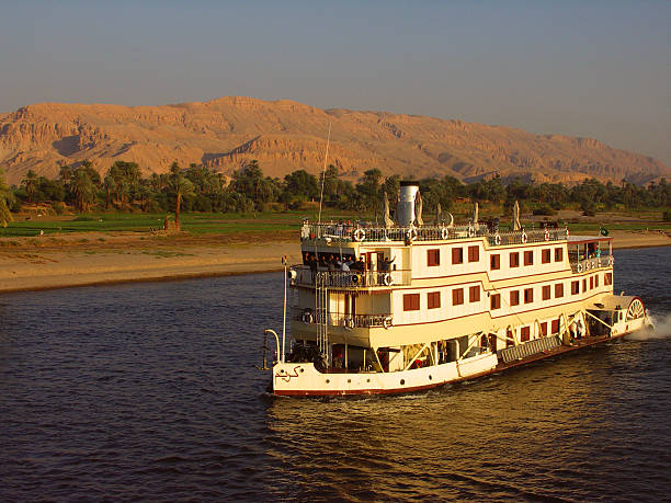 Old fashioned Nile Cruise Ship Egyptian Steamboat on the Nile in the warm evening sun. nile river stock pictures, royalty-free photos & images