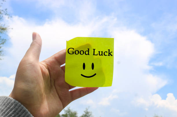 istock Hand holding note writing SMILE smile emoji with blue sky and clouds background. Motivational word wallpaper SMILE written on sticky note 1840991891