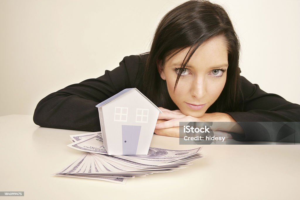 Home Loan Woman with house and money. Note the house is made by me. Note that the house has a faint grain to it. 20-24 Years Stock Photo