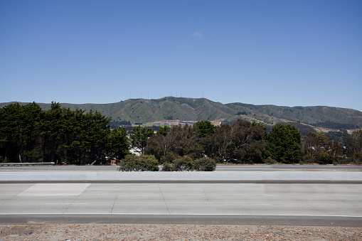 an Empty Interstate 280 with the San Bruno/Santa Cruz Mountains in the background under blue sky as seen from Serramonte Shopping Center in Daly City, California. Horizontal.-For more traffic images, click here.  TRAFFIC 