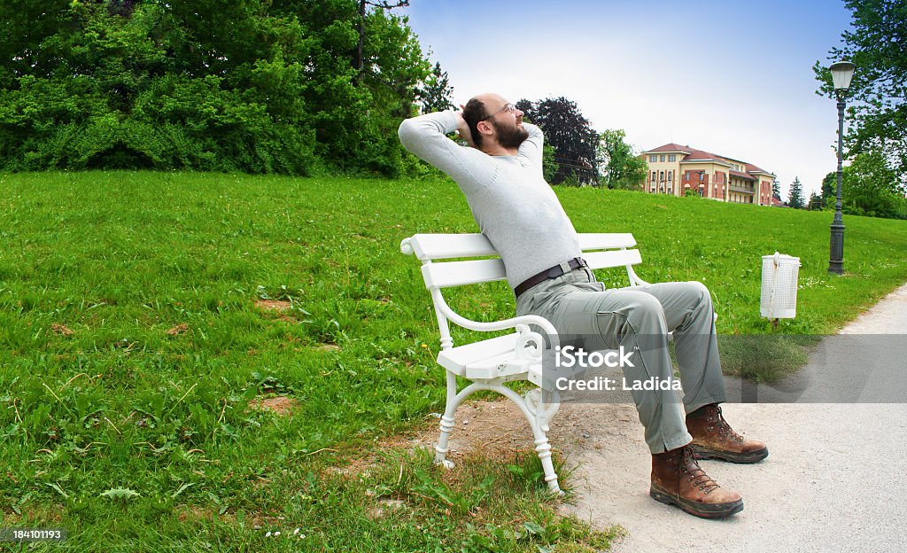 Relaxing on bench man relaxing at the park or dreaming his new house? ;) Adult Stock Photo