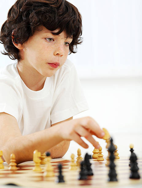 istock Portrait of an 8 year old boy playing chess game. 184101616