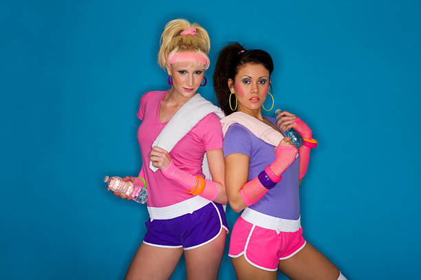1980's fitness girls Two young and attractive 1980's styled fitness models against a blue paper background (taken with a ringflash)Click for Similar Pictures from my Retro Lightbox 80s aerobics stock pictures, royalty-free photos & images