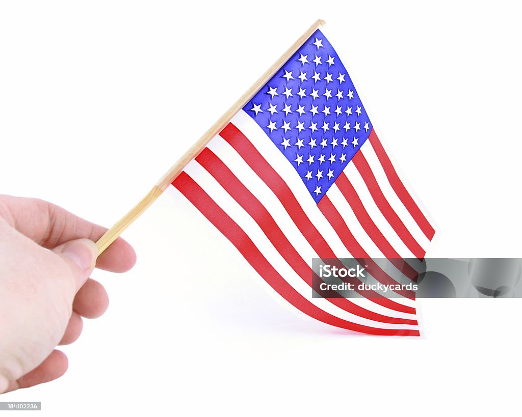 Saludar con la mano de una bandera estadounidense - Foto de stock de Agarrar libre de derechos