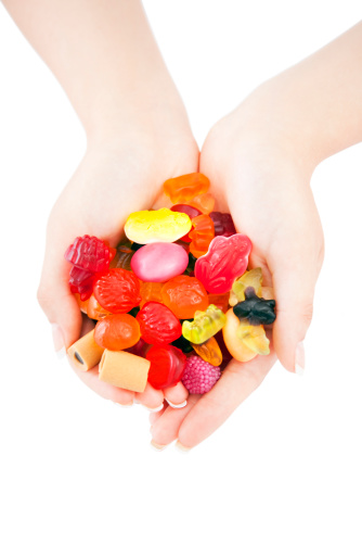 Sweets mix in hands on white