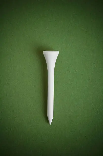 Centered golf tee on green.