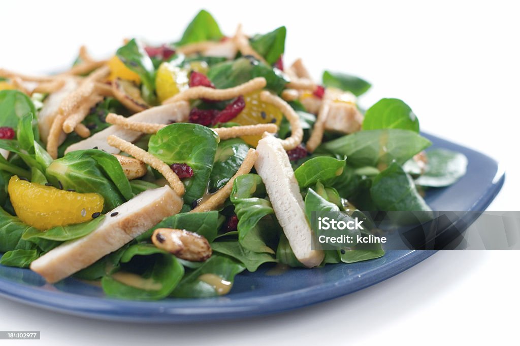 Asian Salad with Chicken "Delicious fresh greens called lamb's lettuce dressed with chunks of tender chicken, mandarin orange segments, almonds, crunchy noodles and a sesame ginger dressing.  Shallow dof." Appetizer Stock Photo