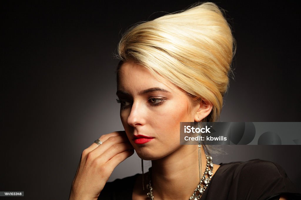 low key pensive blonde fashion model in studio with jewelry Beehive Hair Stock Photo