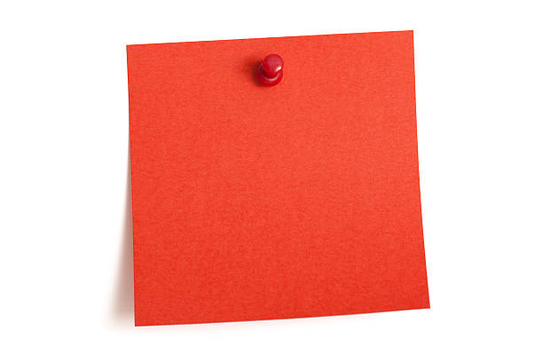 A square blank red note is pinned to a white wall stock photo