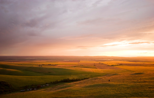 Natural lanscape with bright stormy sky in purple, orange and red tones at dusk