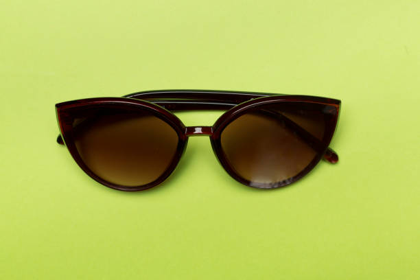 istock Sunglasses on color background, top view. 1841039825
