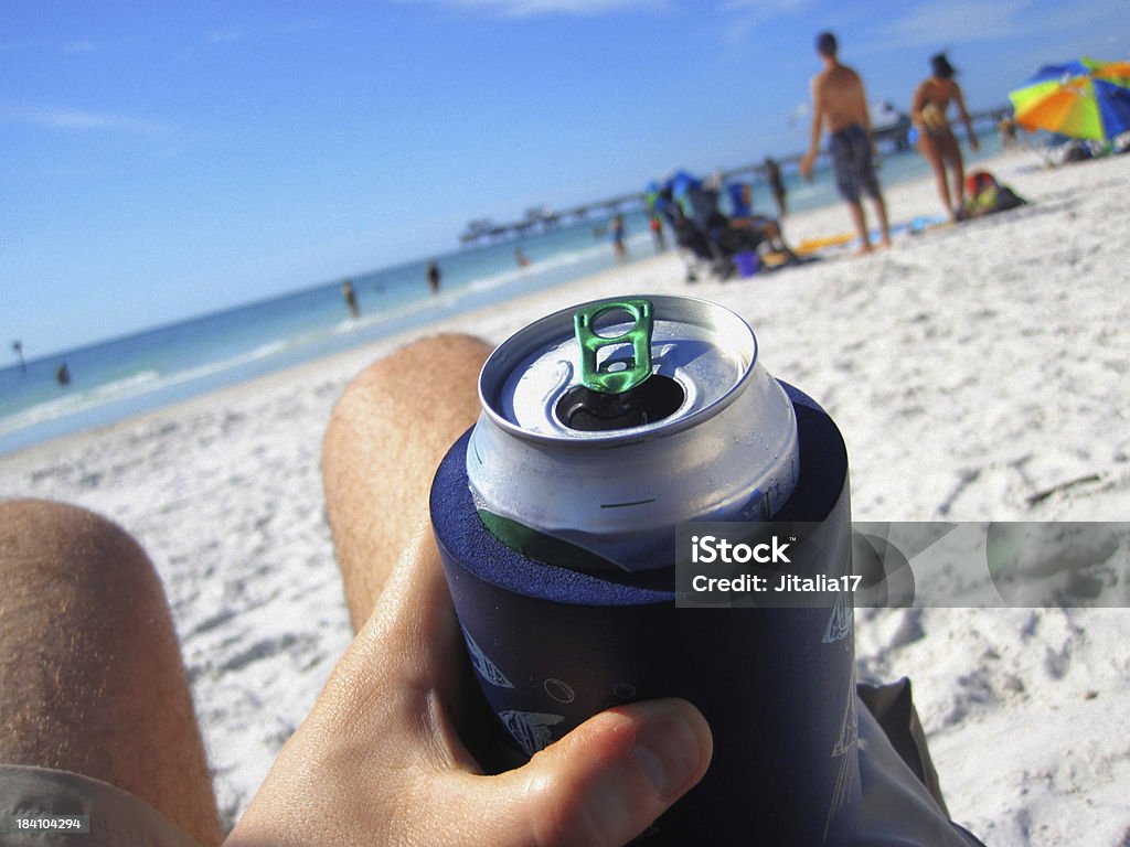 Man Drinking a Can of Beer at the Beach "Photograph of a man enjoying a cold can of beer on a hot summer day -- this was shot with a macro lens, focus is on the pulltab of the beer can." Can Stock Photo