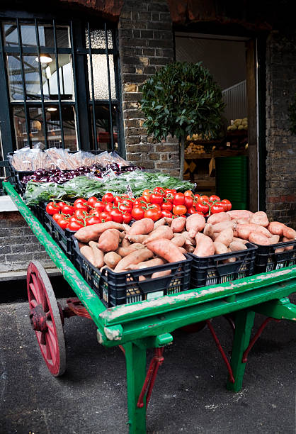 Vegetable barrow outside a greengrocery shop