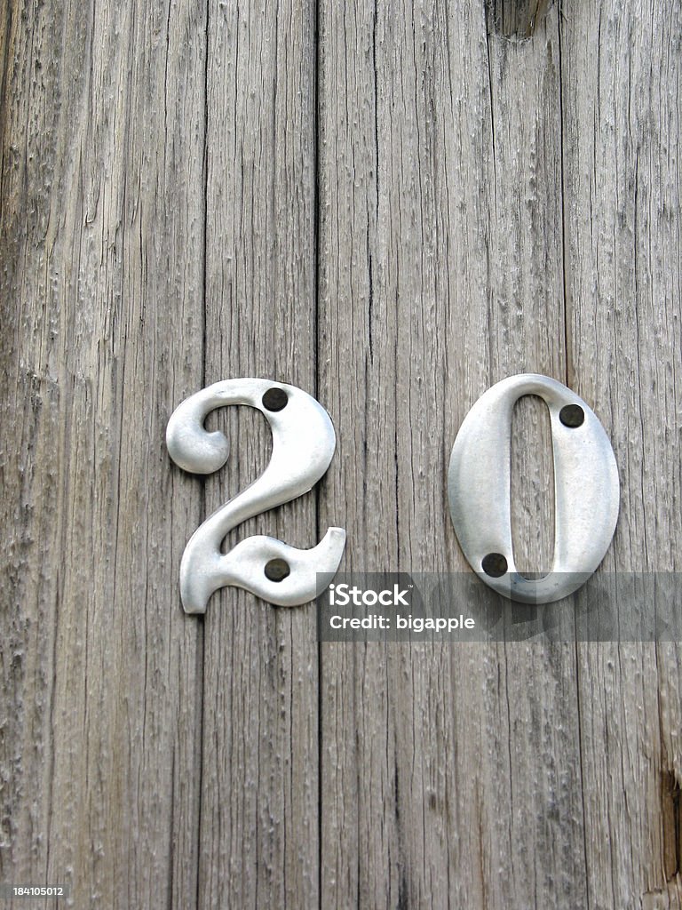 Aluminum Twenty Numerals on a wooden pole Aluminum Stock Photo