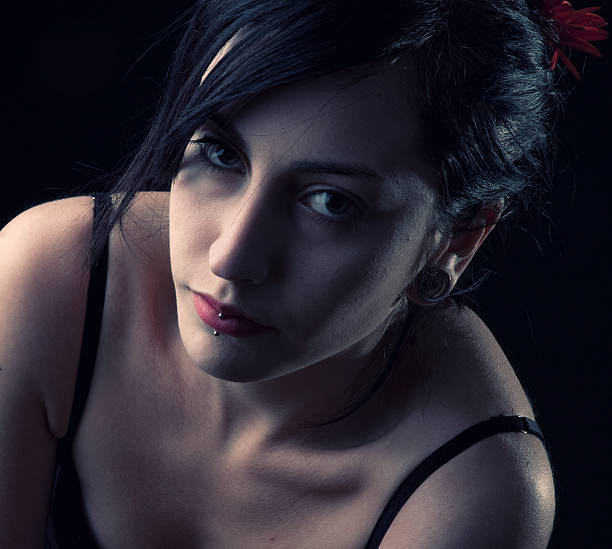 istock beautiful girl posing in studio on black background 184105050