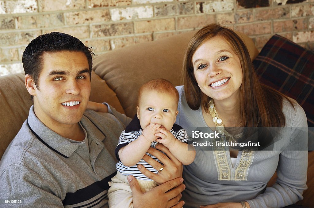 Happy Family parents posing with new baby 0-11 Months Stock Photo