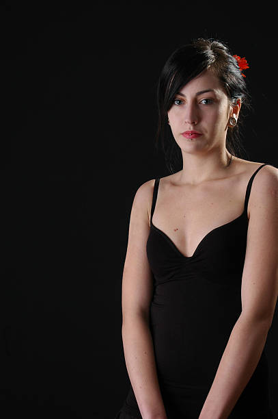 istock beautiful girl posing in studio on black background 184105718