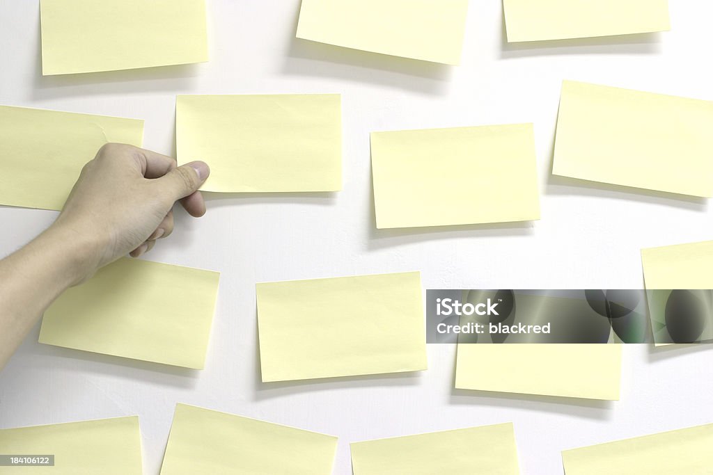 Posted Hand picking one of many sticky notes from the wall.Similar images - Wall - Building Feature Stock Photo