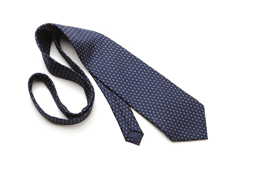 Blue patterned necktie laying on white background