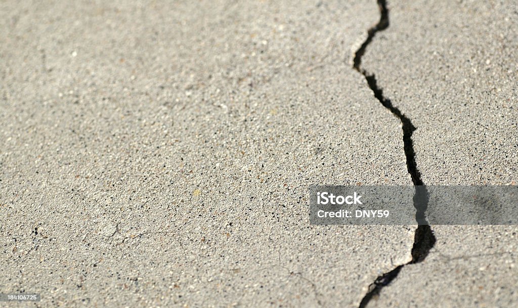 Crack Crack in concrete with room for text and copy. Breaking Stock Photo