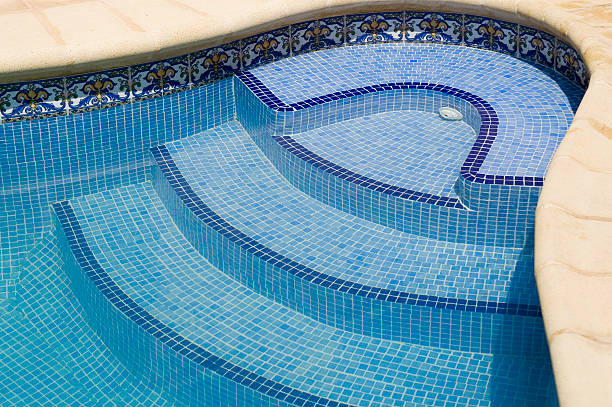 Into the pool Blue tiled stairs of a swimming pool.Please also see : ghat photos stock pictures, royalty-free photos & images