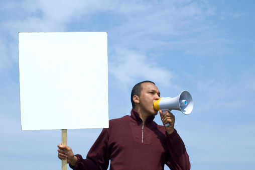 man with megaphone and banner