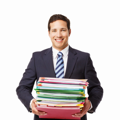 Handsome young businessman carries a stack of folders and paperwork in his hands. Square shot. Isolated on white.