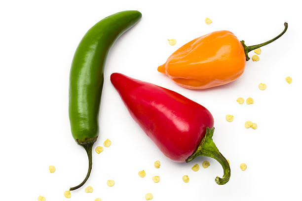 Three different colored and shaped peppers isolated on white stock photo