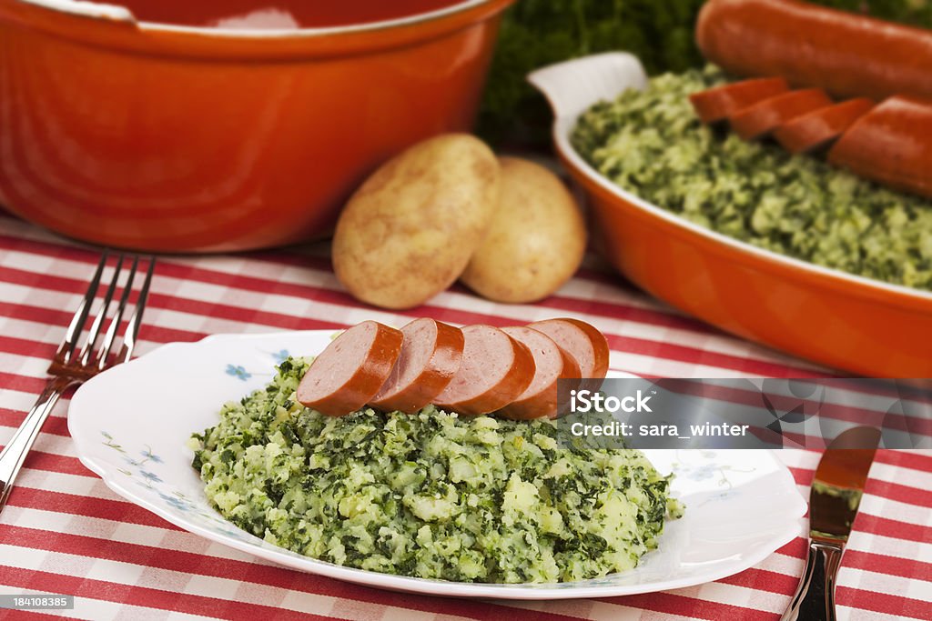 Dutch food: kale with smoked sausage or 'Boerenkool met worst' "'Boerenkool met worst' - a traditional Dutch dish with mashed potatoes, kale and smoked sausage." Kale Stock Photo