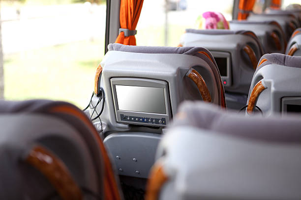 Plush Bus Travel Modern luxury bus travel interior.Television in armchair. vehicle interior audio stock pictures, royalty-free photos & images