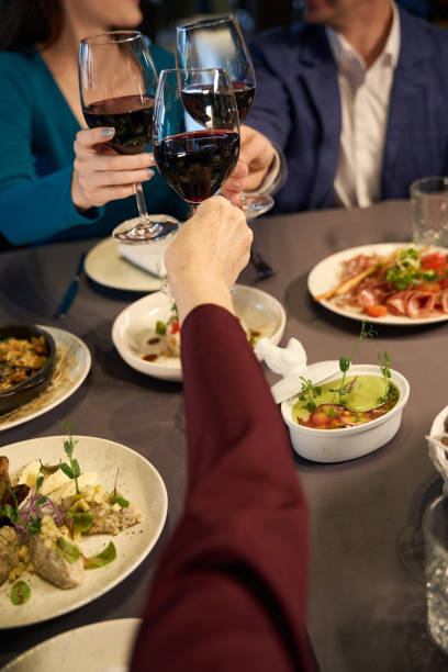 istock People toasting and clicking glasses of wine on celebration 1841087073