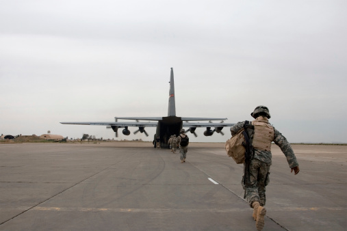 A soldier loads up onto an American plane near Mosul, Iraq.