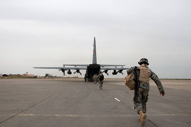 Loading up A soldier loads up onto an American plane near Mosul, Iraq. military deployment photos stock pictures, royalty-free photos & images