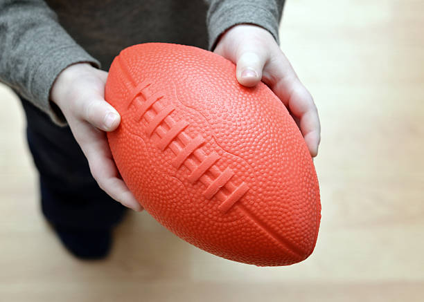 istock Football in Hand 184109088