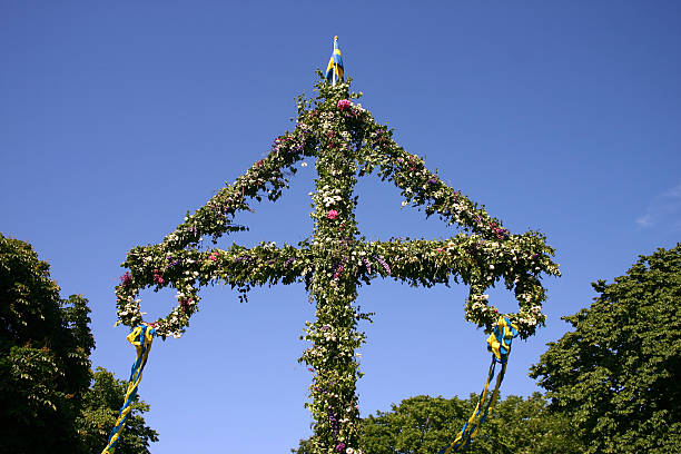 Swedish midsummer pole decorated with flowers and wreaths stock photo