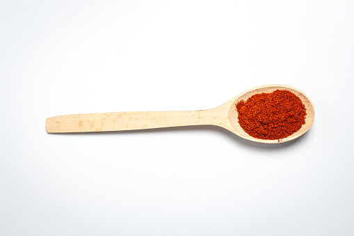 Fragrant different spices in spoons on a white background