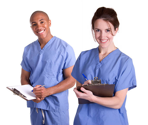 Male and Female Nurses with Clipboards stock photo