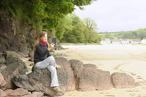 istock Mature woman outdoors with electronic tablet 184110564
