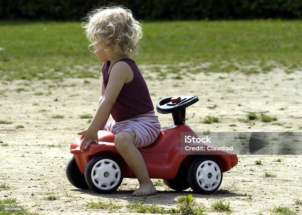 Wrong direction Child sits on a bobby car Child Stock Photo