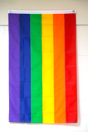 rainbow LGBT flag hanging on wall, LGBT concept