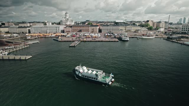 Aerial, tour boat in front of Helsinki market with view of the cathedral