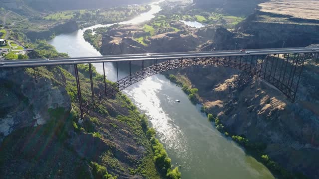 A 4K fly-over drone shot of Perrine Bridge, a 1,500 foot long bridge, spanning over the Snake River in Twin Falls, Idaho. One of the few locations in the U.S.A where it is legal to go base-jumping.