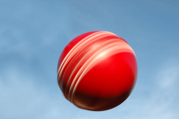 Leather Cricket Ball spinning against sky stock photo