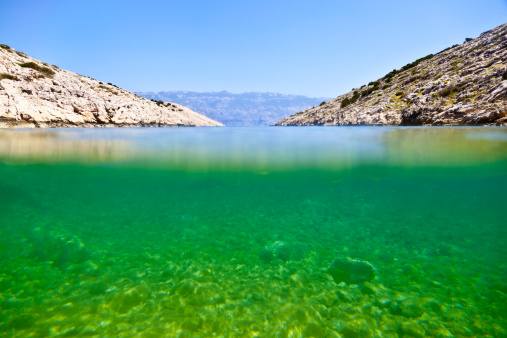 Underwater/water surface shot of deserted beach at Croatian island Pag.
