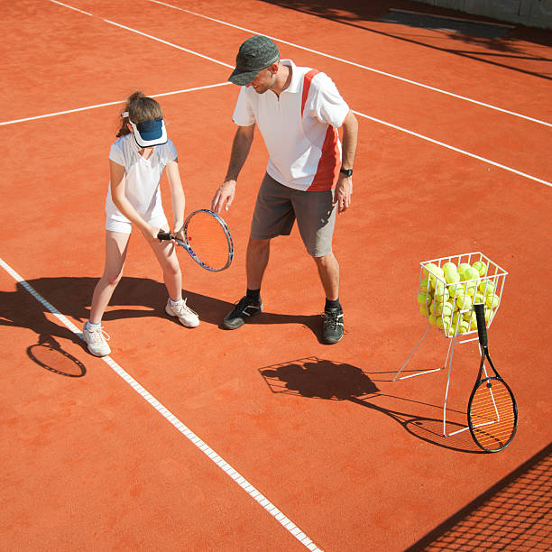 istock Tennis coach in class with young girl 184112522