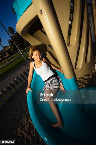 Foto de Adolescente Em Um Playground Slide e mais fotos de stock de Adolescente - Adolescente, Adulto, Brilhante - Luminosidade