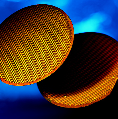 Silicon Wafers floating in a blue background. Used for various computer and technology driven machines.