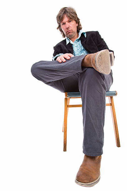 istock Scruffy serious man on chair 184113188