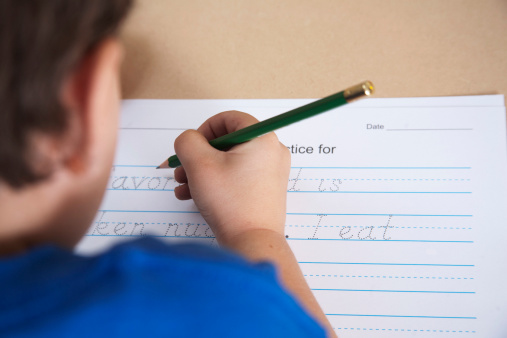 A young boy works on his handwriting.